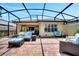 Inviting screened-in patio area with cozy furniture and access to the backyard at 11854 Delfina Ln, Orlando, FL 32827