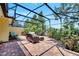 Relaxing screened-in patio with comfortable seating and a lush garden at 11854 Delfina Ln, Orlando, FL 32827