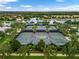 Aerial view of multiple tennis courts surrounded by lush landscaping, perfect for active community residents at 11854 Delfina Ln, Orlando, FL 32827