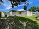 A spacious backyard featuring a weathered fence and lush lawn at 1256 N Pine Hills Rd, Orlando, FL 32808