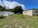This backyard showcases a white privacy fence and some lawn area at 1256 N Pine Hills Rd, Orlando, FL 32808