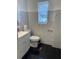 Modern bathroom with marble-style tile, dark floors, and bright natural light at 1256 N Pine Hills Rd, Orlando, FL 32808