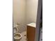 Small bathroom with tiled walls, toilet, and a basic vanity setup at 1256 N Pine Hills Rd, Orlando, FL 32808