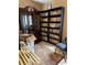 The office features floor to ceiling bookcases, a cabinet, and an area rug at 1256 N Pine Hills Rd, Orlando, FL 32808