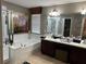 Bathroom featuring a soaking tub, separate shower, and vanity with double sinks at 13252 Vennetta Way, Windermere, FL 34786