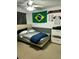 Bedroom with a bed, dresser, and Brazilian flag decor at 13252 Vennetta Way, Windermere, FL 34786