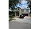 Two-story home featuring a two-car garage and a front porch, plus a brick paved driveway at 13252 Vennetta Way, Windermere, FL 34786