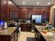 Spacious kitchen with granite countertops, stainless steel appliances, and dark wood cabinetry at 13252 Vennetta Way, Windermere, FL 34786
