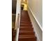 Wooden staircase with white railing leading to the upper level of the home at 13252 Vennetta Way, Windermere, FL 34786