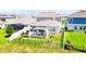 Aerial view of a fenced backyard with a covered patio, lush green lawn, and meticulous landscaping at 13993 Title Way, Winter Garden, FL 34787