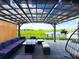 Backyard patio area with modern pergola, plush seating, and an outdoor fire pit overlooking a beautiful water view at 13993 Title Way, Winter Garden, FL 34787