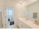 Bright bathroom featuring double vanity, chrome fixtures, and a view of the toilet and shower at 13993 Title Way, Winter Garden, FL 34787