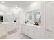 Bright bathroom with double sinks, white cabinets, quartz countertops, and modern fixtures at 13993 Title Way, Winter Garden, FL 34787