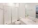 Bathroom featuring white tile shower, glass door, and a modern vanity at 13993 Title Way, Winter Garden, FL 34787