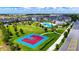 Aerial view of a community park with a splash pad, swimming pool, playground, and basketball court at 13993 Title Way, Winter Garden, FL 34787