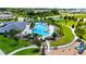 Aerial view of a resort-style community pool area with lush landscaping, seating, and recreational amenities at 13993 Title Way, Winter Garden, FL 34787