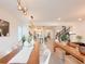 Bright, open dining area with modern light fixtures and view of the kitchen and staircase at 13993 Title Way, Winter Garden, FL 34787
