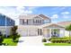 Beautiful two-story home featuring a symmetrical facade, a two-car garage, and a manicured front yard at 13993 Title Way, Winter Garden, FL 34787