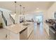 Bright, open-concept kitchen with island, stainless appliances, and a seamless flow to dining and living areas at 13993 Title Way, Winter Garden, FL 34787
