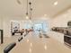 Open-concept kitchen boasts a large island with bar seating and views of the living and dining areas at 13993 Title Way, Winter Garden, FL 34787