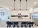 Stylish kitchen featuring a spacious island with seating, pendant lighting, and stainless steel appliances at 13993 Title Way, Winter Garden, FL 34787