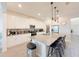 Modern kitchen with a large center island, stainless steel appliances, and sleek white cabinetry at 13993 Title Way, Winter Garden, FL 34787