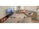 Open living room with a large sectional sofa, modern media center, stylish decor, and neutral-toned accents at 13993 Title Way, Winter Garden, FL 34787