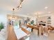 Open-concept living space with stylish decor and a seamless flow between the kitchen, dining, and living areas at 13993 Title Way, Winter Garden, FL 34787