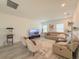 Bright living room features an elegant sofa, a large screen TV, and a cozy seating arrangement at 13993 Title Way, Winter Garden, FL 34787