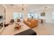 Open-concept living room with tile floors, modern decor, and sliding glass doors to the backyard at 13993 Title Way, Winter Garden, FL 34787