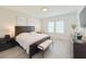 Well-lit main bedroom with large bed, bench, and serene decor with a peaceful ambiance at 13993 Title Way, Winter Garden, FL 34787