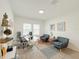Well-lit home office features stylish seating, glass desk, and shelving with decorative accents at 13993 Title Way, Winter Garden, FL 34787