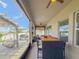 Covered patio featuring a full dining set, ceiling fan, and views of the backyard at 13993 Title Way, Winter Garden, FL 34787
