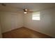 Comfortable bedroom with wood floors, a ceiling fan, and a window for natural light at 16320 3Rd St, Umatilla, FL 32784