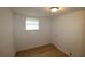 Bedroom with wood-look flooring, a window, and a closet with a flush door at 16320 3Rd St, Umatilla, FL 32784
