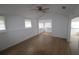 Bright and airy living room featuring wood floors and neutral tones, leading to other rooms at 16320 3Rd St, Umatilla, FL 32784