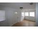 Bright living room features wood flooring, white walls, and plenty of natural light from the windows at 16320 3Rd St, Umatilla, FL 32784