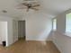 Spacious living room with wood floors, white walls, and a ceiling fan for added comfort at 16320 3Rd St, Umatilla, FL 32784