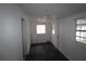 View of a utility room with black tile flooring, a window, and exterior door at 16320 3Rd St, Umatilla, FL 32784