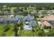 Aerial view featuring multiple homes, manicured green lawns, and in-ground pools at 1741 Edgewater Dr, Mount Dora, FL 32757