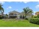 Spacious backyard with lush landscaping and an exterior view of the home at 1741 Edgewater Dr, Mount Dora, FL 32757