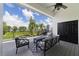 Relaxing balcony with comfortable seating and scenic views of the lake and lush greenery at 1741 Edgewater Dr, Mount Dora, FL 32757