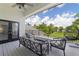 Relaxing balcony with comfortable seating and scenic views of lush greenery and blue skies at 1741 Edgewater Dr, Mount Dora, FL 32757