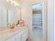 Bright bathroom with white cabinets, marble countertop, and a view to the tiled shower at 1741 Edgewater Dr, Mount Dora, FL 32757