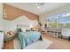 Charming bedroom featuring a cozy bed, natural light, and a functional desk area at 1741 Edgewater Dr, Mount Dora, FL 32757