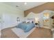 Well-lit bedroom with a comfortable bed, neutral decor, and a view of the adjacent bathroom at 1741 Edgewater Dr, Mount Dora, FL 32757