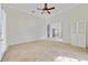 Large bonus room with neutral carpet and white wainscoting at 1741 Edgewater Dr, Mount Dora, FL 32757