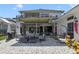 Rear exterior showcasing a covered patio and balcony, perfect for outdoor entertaining at 1741 Edgewater Dr, Mount Dora, FL 32757