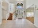 Grand two-story foyer with tile flooring, staircase, and lots of natural light at 1741 Edgewater Dr, Mount Dora, FL 32757