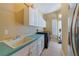 Laundry room featuring tile flooring, countertop space, cabinets, sink and modern appliances at 1741 Edgewater Dr, Mount Dora, FL 32757